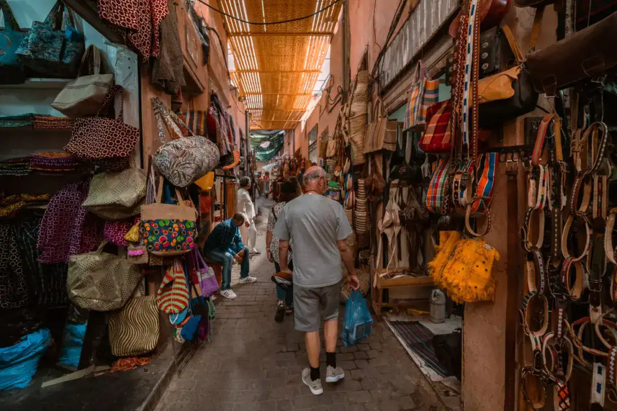 Ruelle couverte d’un souk de Marrakech, bordée d’échoppes de sacs, de paniers et d’articles en cuir