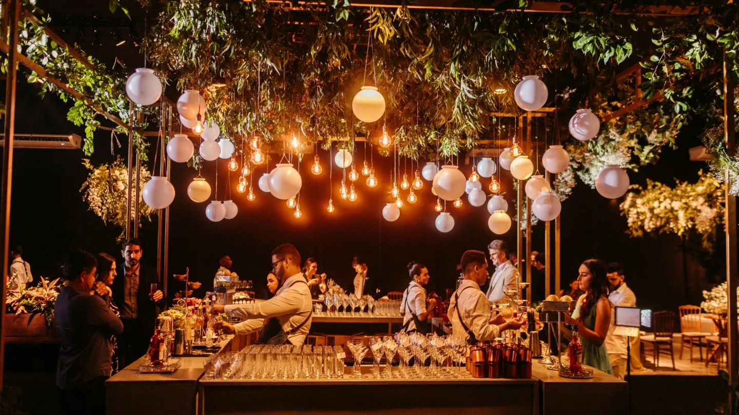 Reception bar set up under lanterns and strings of lights on a gala evening