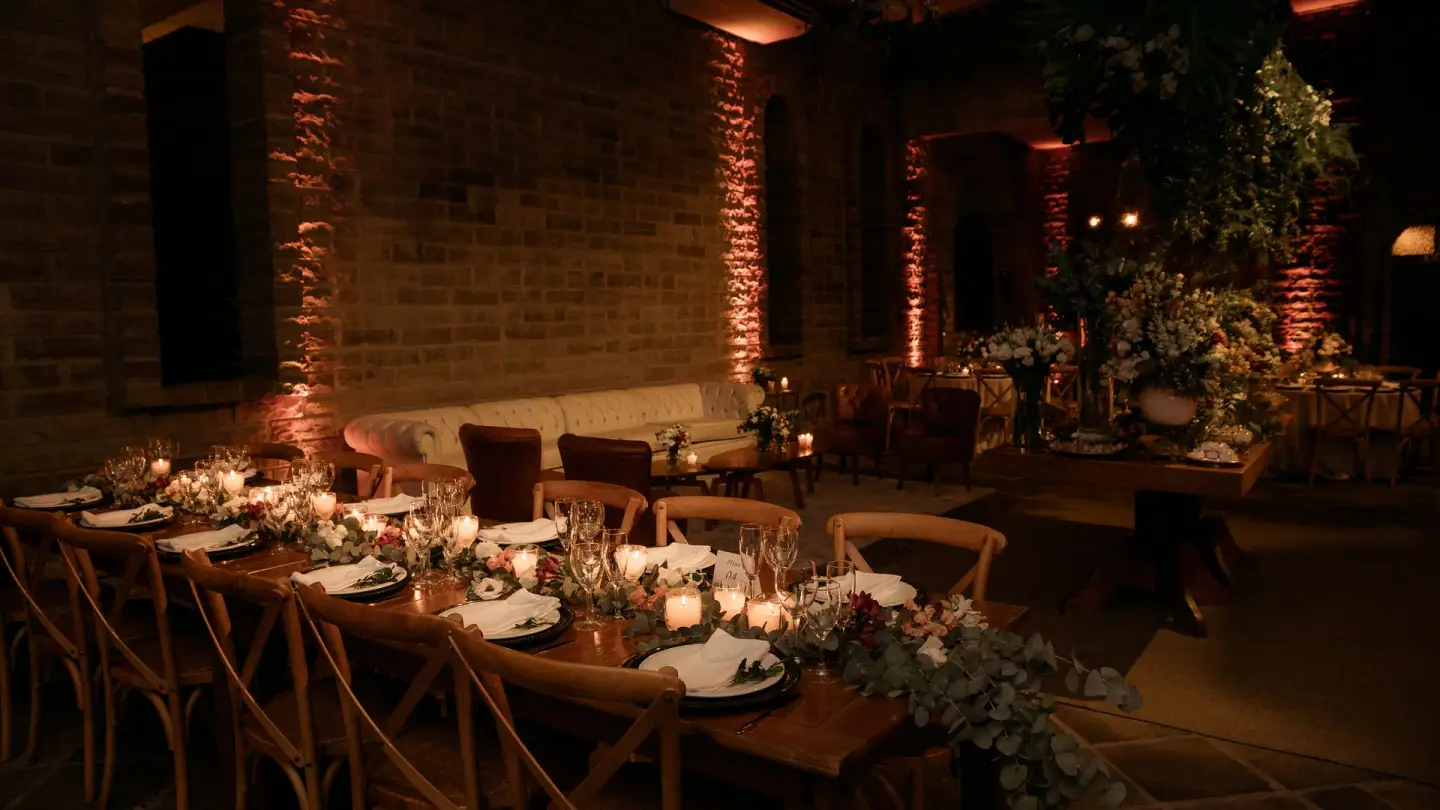 Long candlelit wedding table under strings of lights